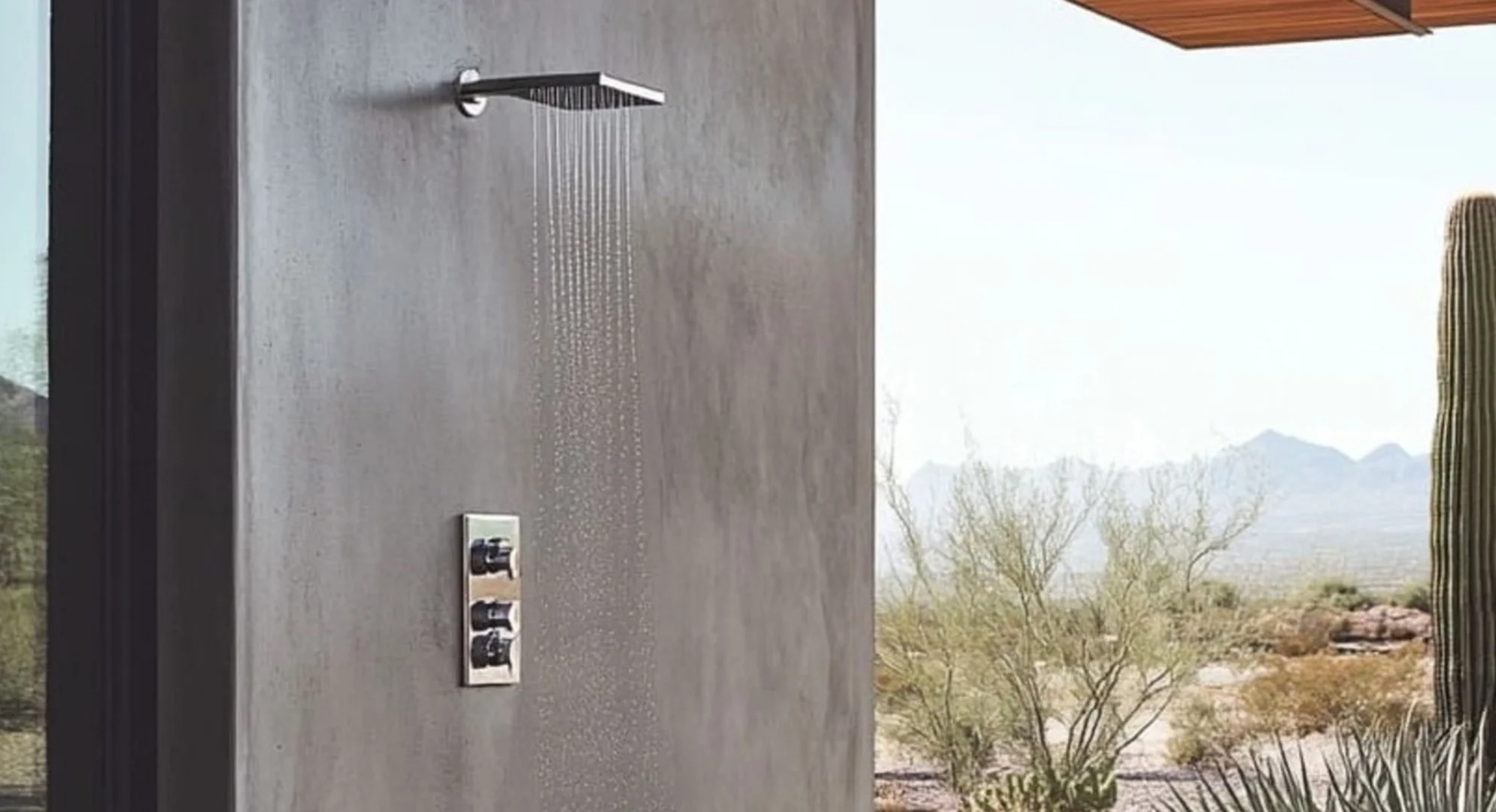 A-square-rainfall-shower-head-in-brushed-stainless-steel-extends-outward-its-linear-design-mirroring-the-modern-architecture-of-the-surrounding-space (1) (1)